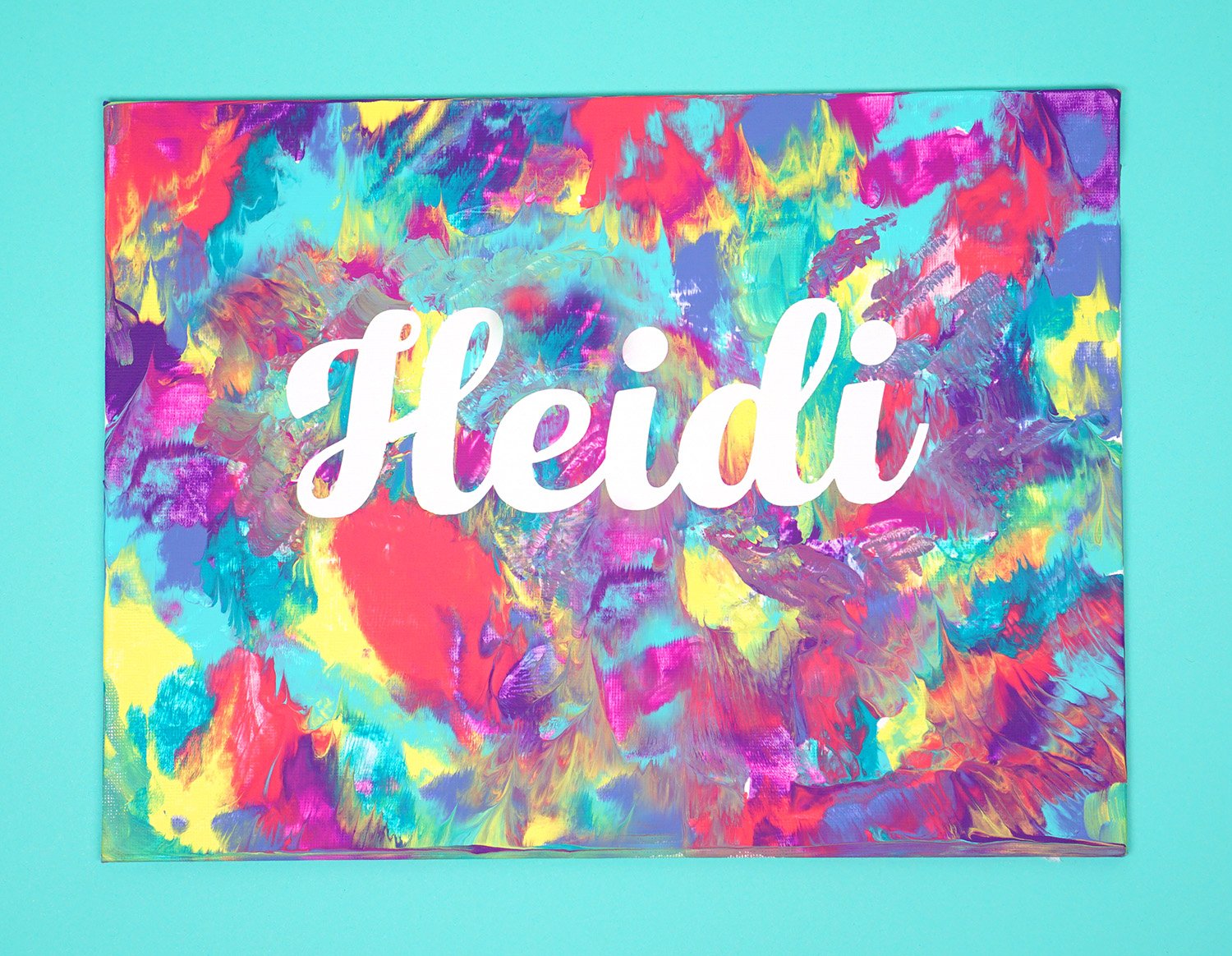 vinyl pealed to reveal white name \"Heidi\" in splatter paint 