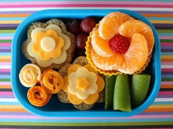 snacks arranged to look like flowers in bento box