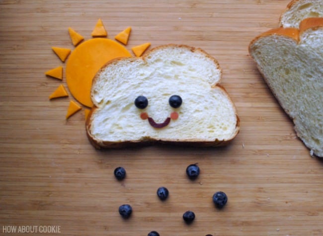 smiling rain cloud sandwich with sun and rain drops made from foods