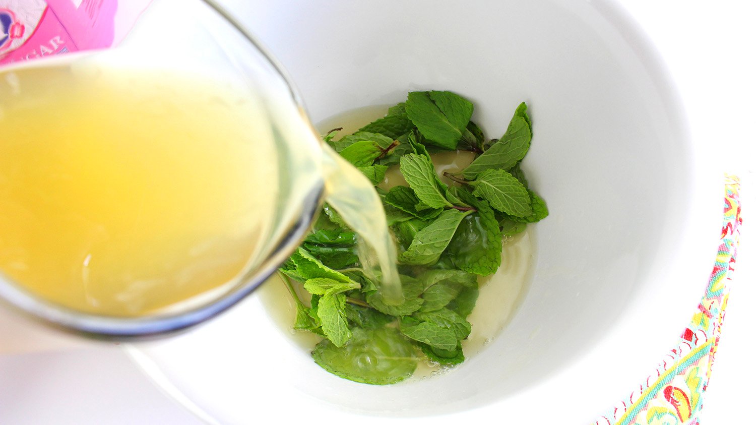 pouring mixture and mint into bowl