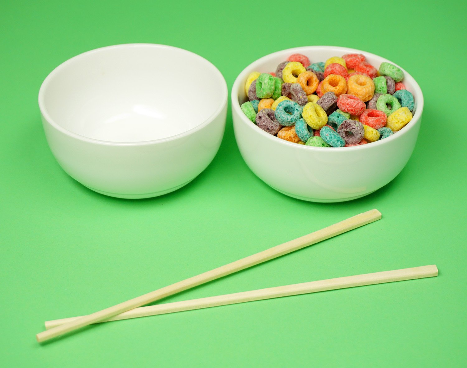 empty bowl, bowl filled with cereal and two chop sticks