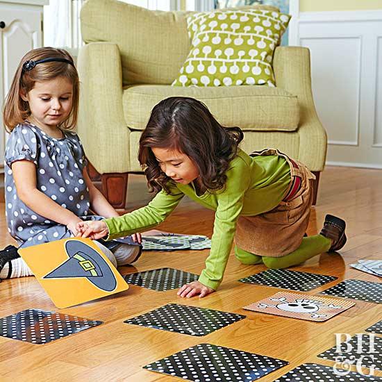 kids playing halloween matching game on floor