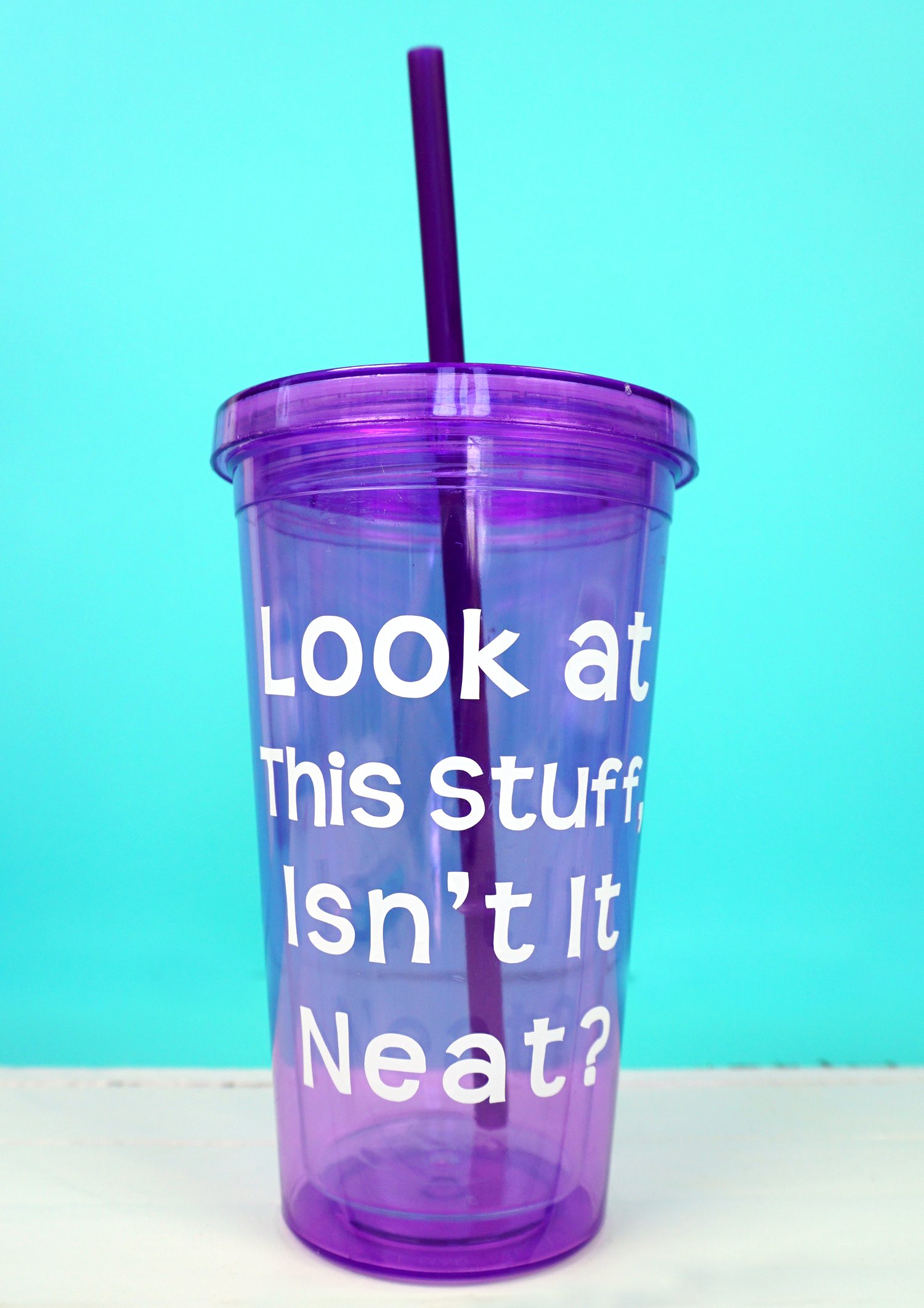 purple tumbler with curved text