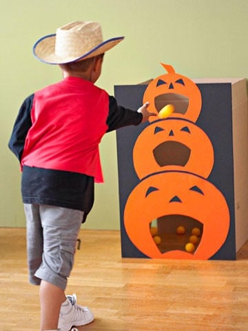 pumpkin toss halloween game being played by kid