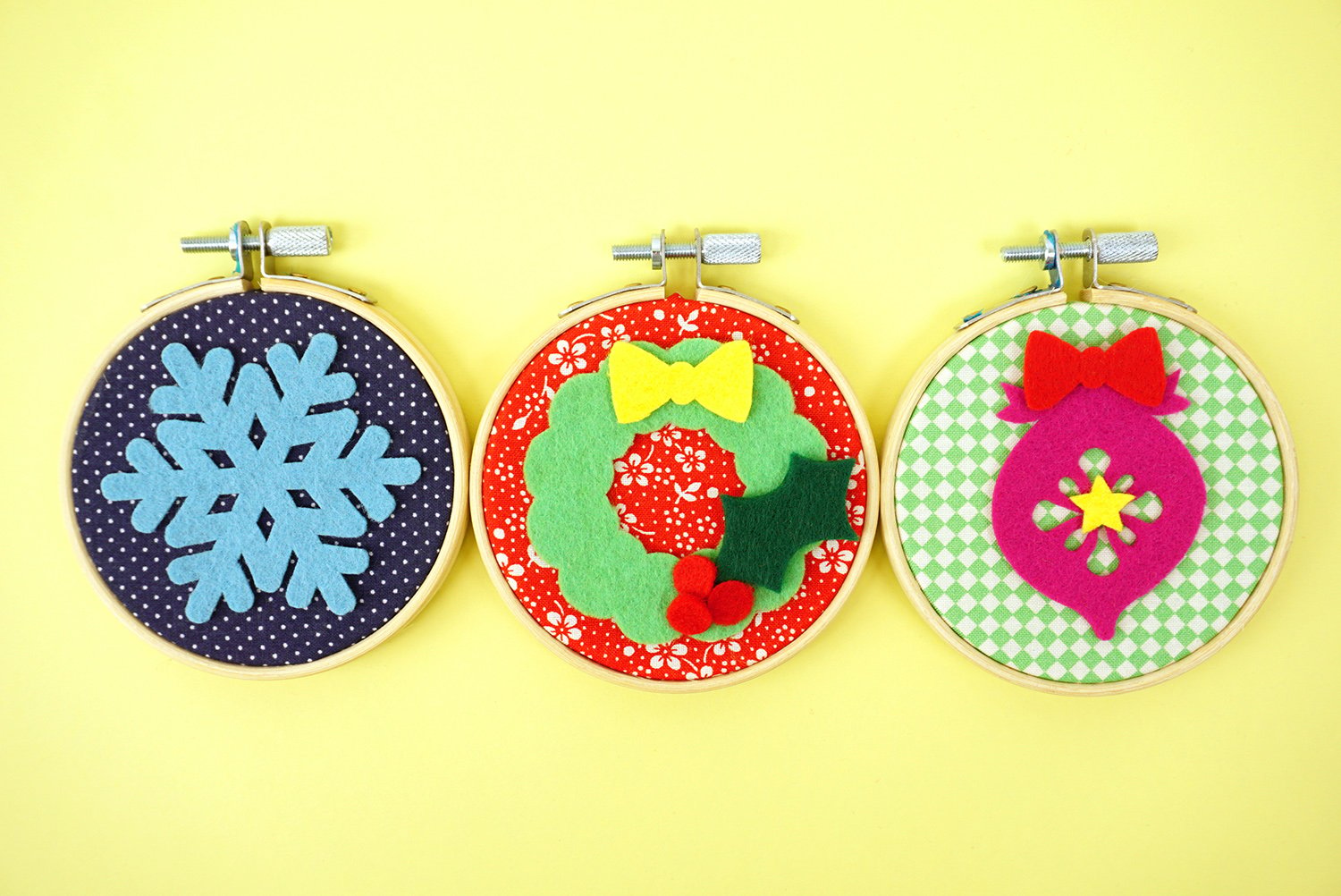 christmas cut out felt pieces adhered to embroidery hoop designs