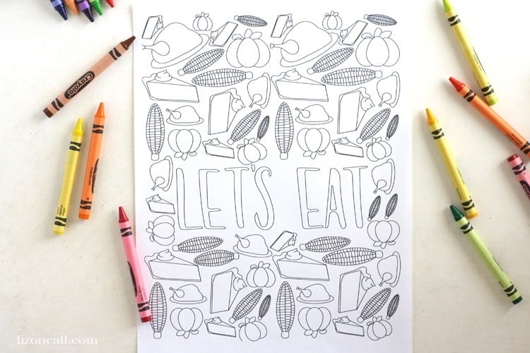 "Let's Eat" Thanksgiving coloring page with crayons on white background