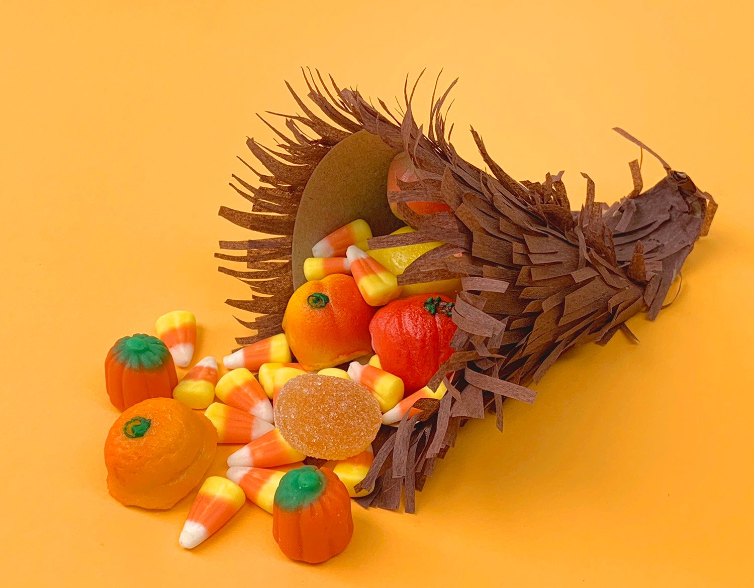 cornucopia spilling out candy and pumpkins 