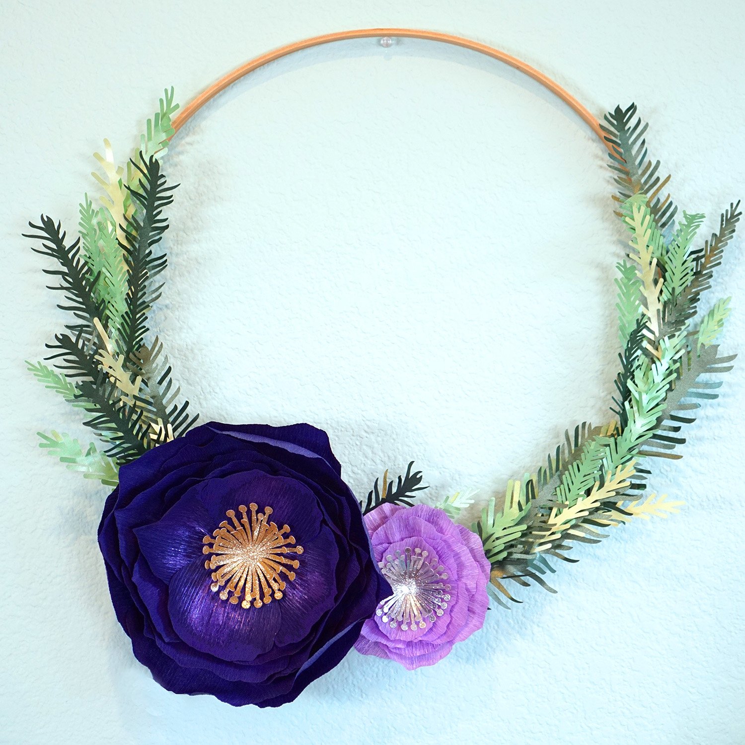 crepe paper flower wreath hung on wall