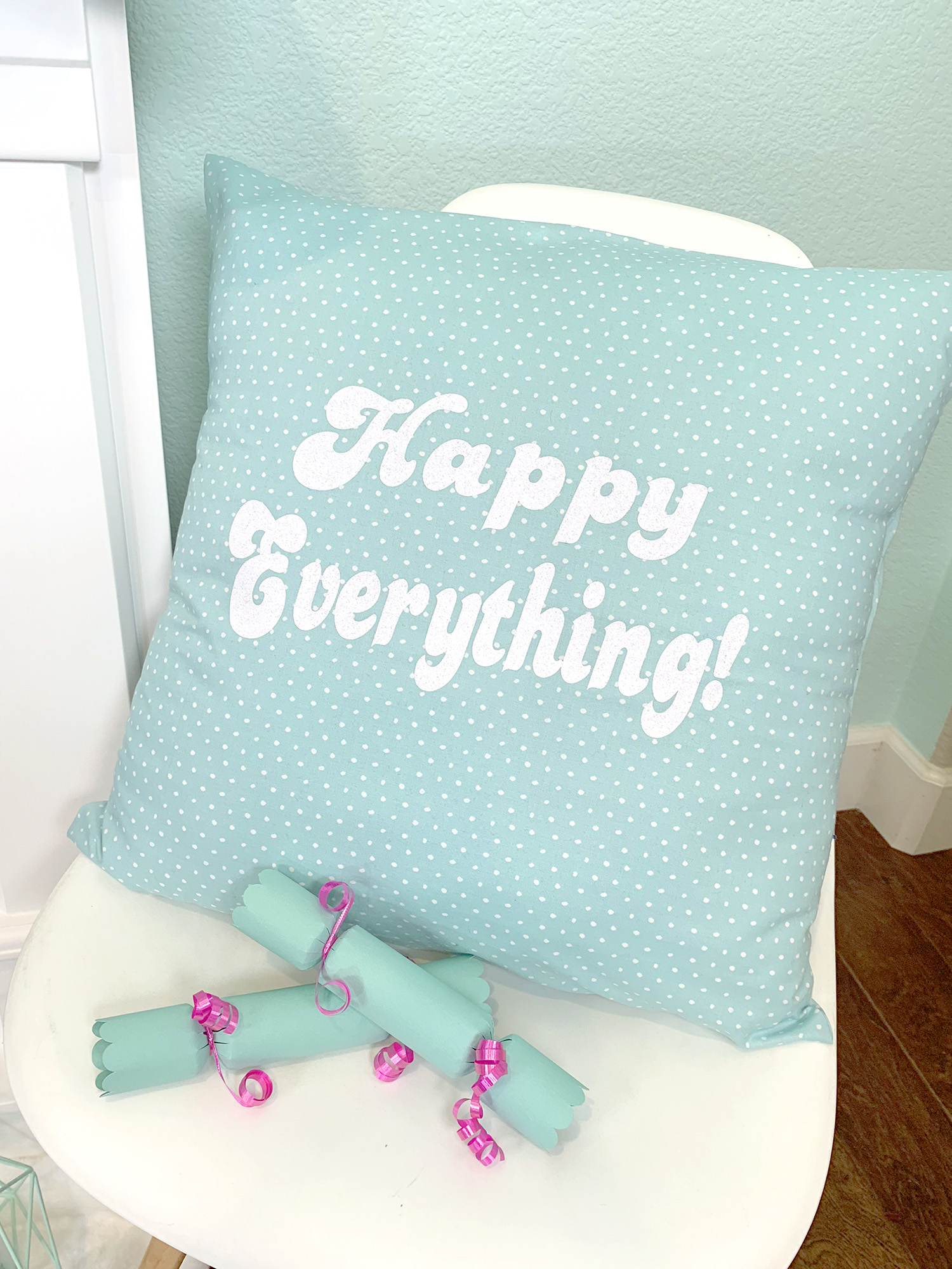 happy everything pillow in chair