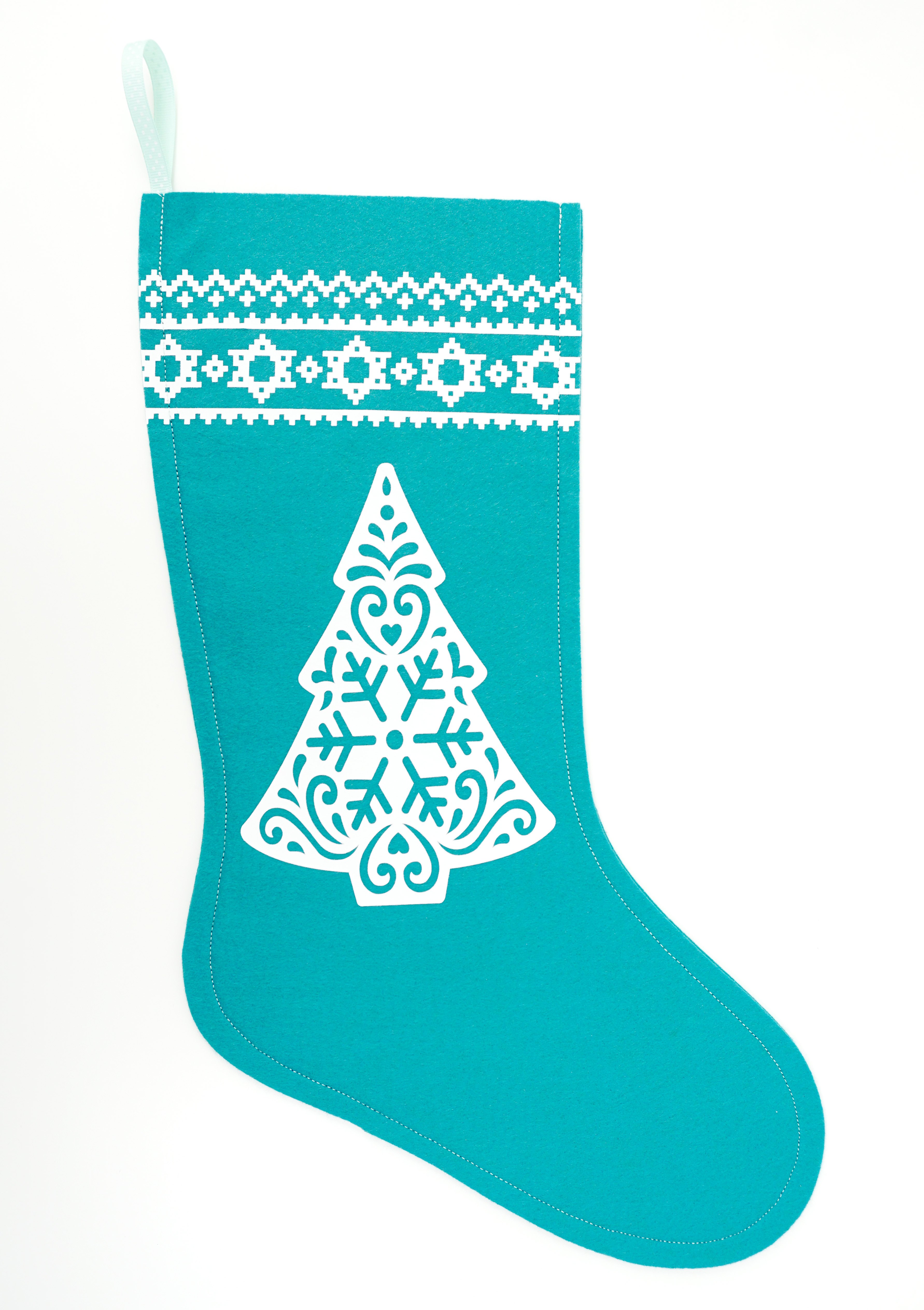 blue stocking with white christmas tree and embellishments