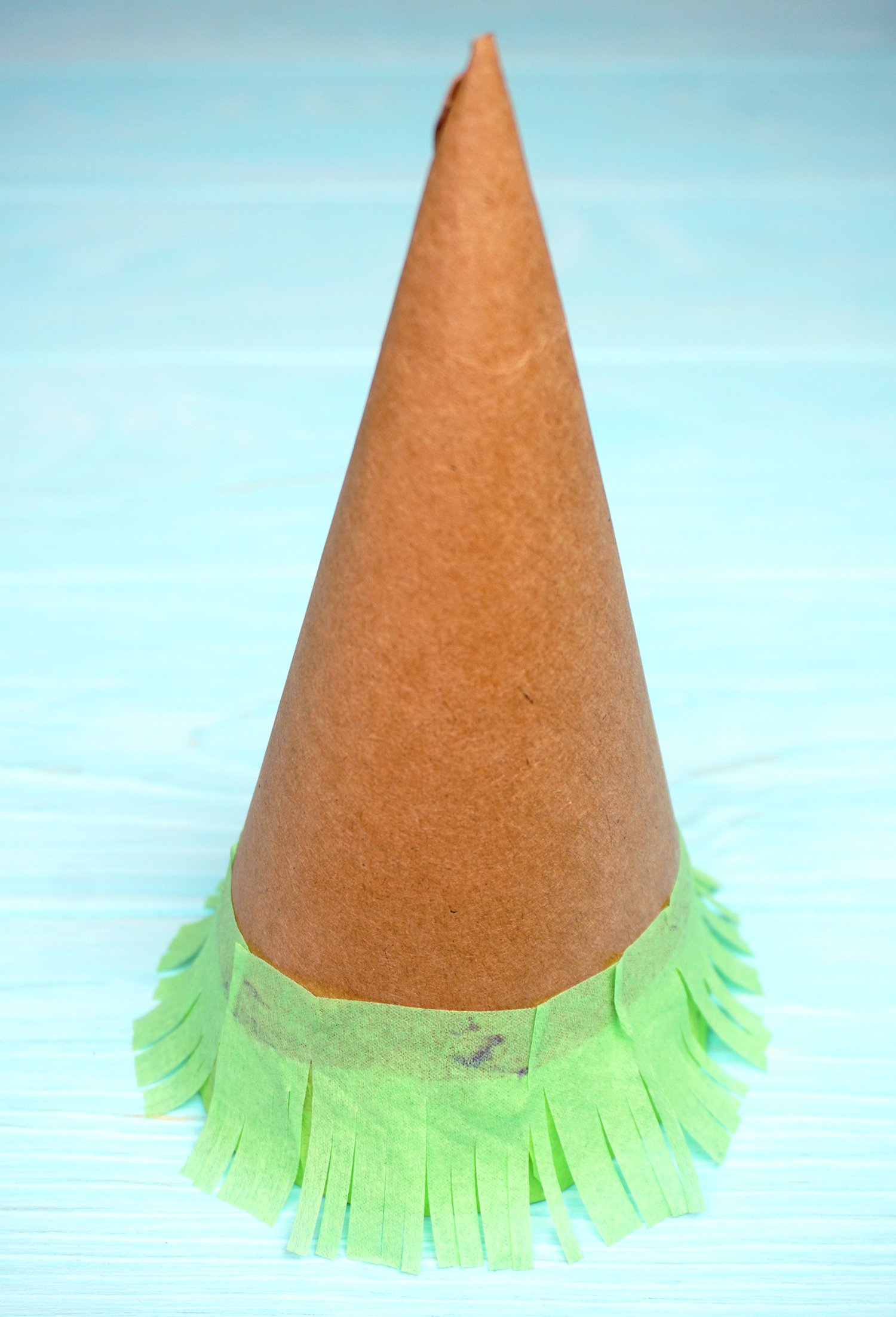glueing fringed crepe paper to sides of cone
