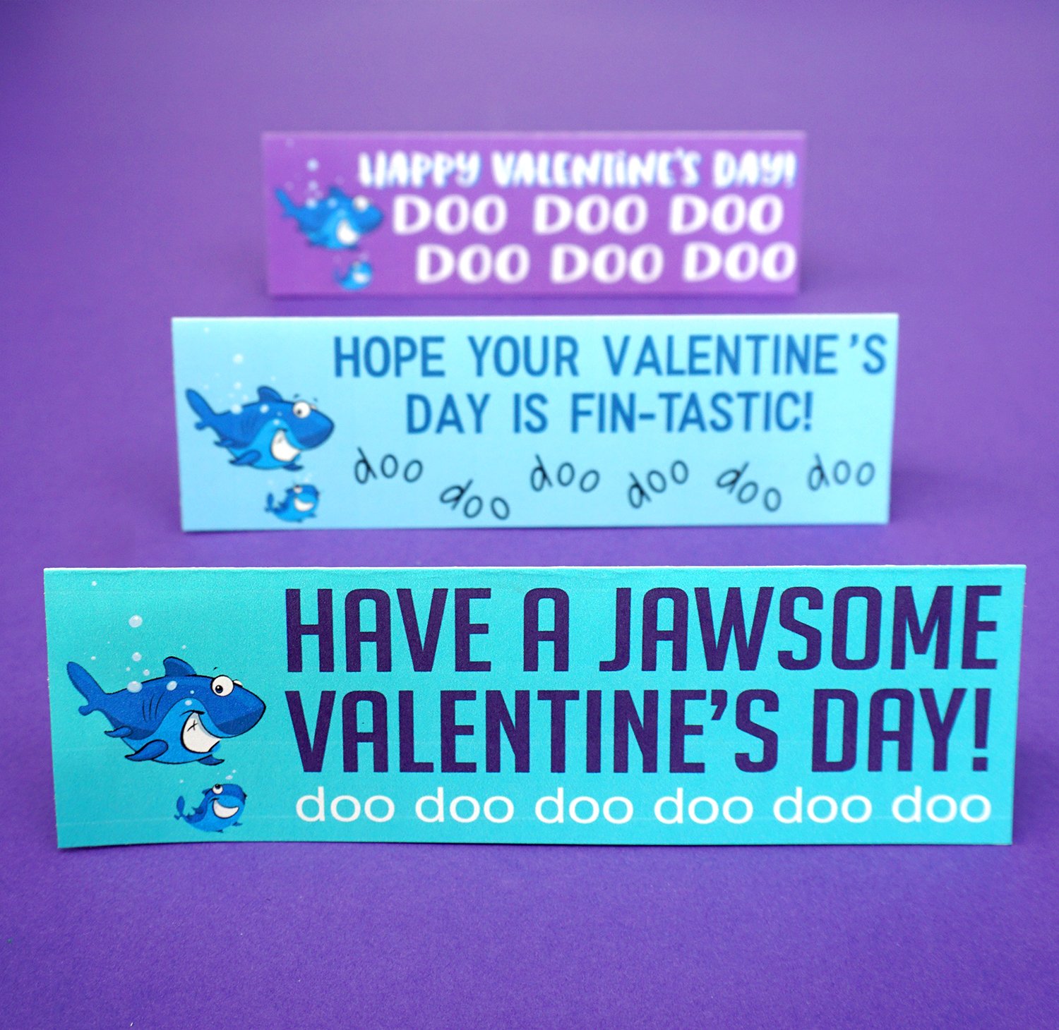 Baby Shark Valentine's Day Treat: Are your kids obsessed with Baby Shark? Take their love to the next level with these FREE Baby Shark Printable Valentines Cards! Baby Shark Valentines Cards - Folded on Purple Background