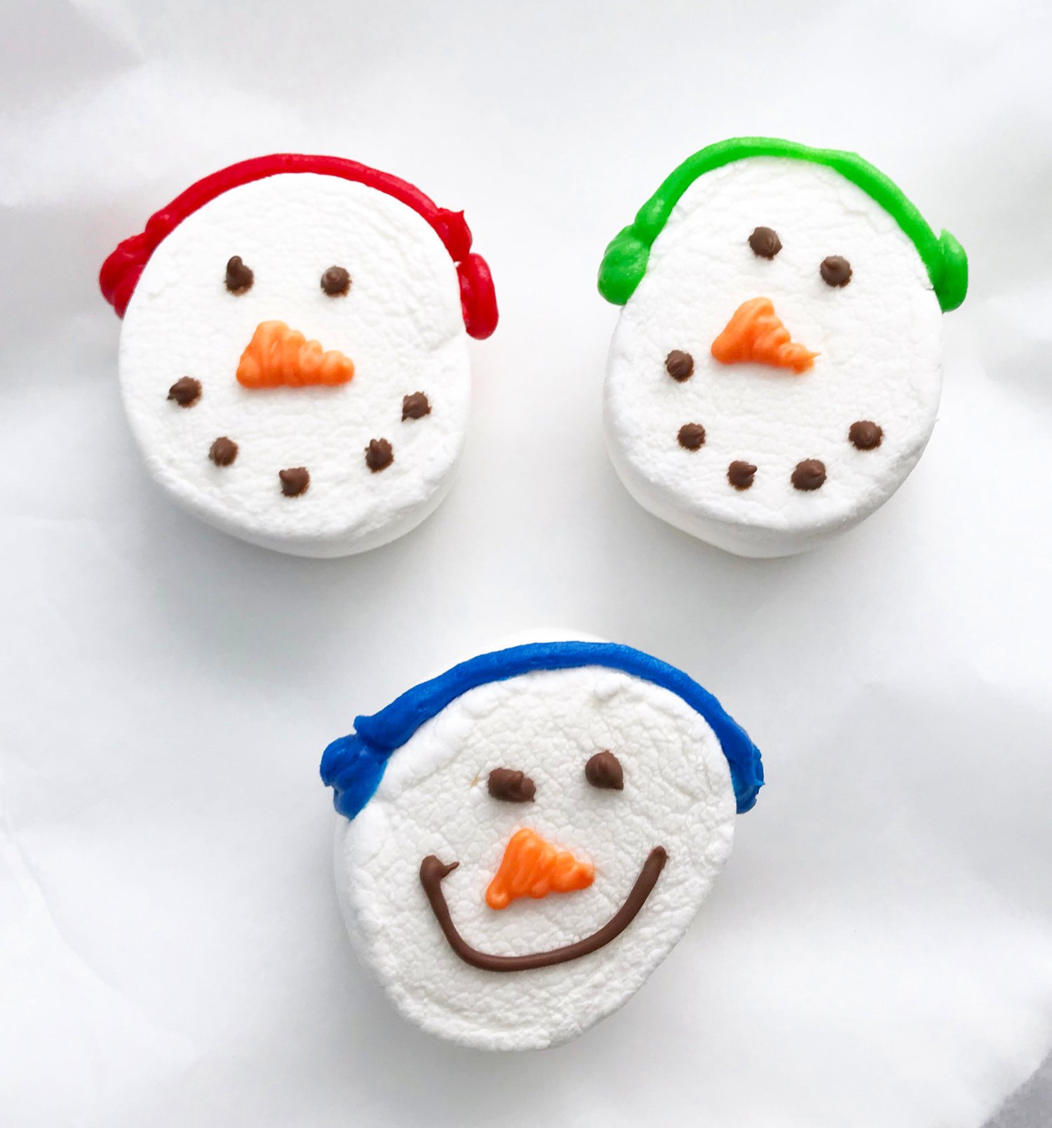smiling snowman marshmallows wearing ear muffs