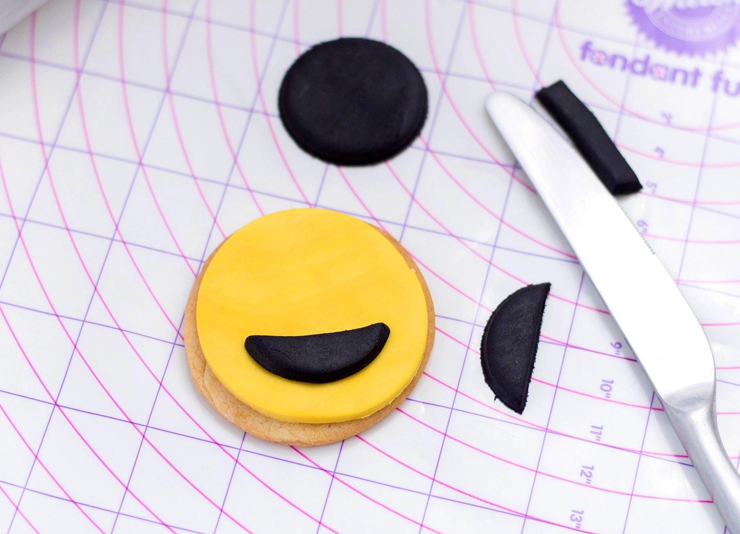 adding cut out mouths to cookies