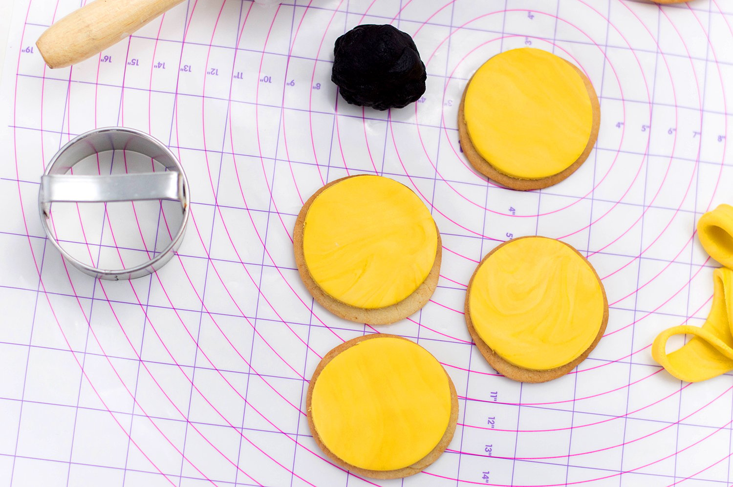 placing circular shapes onto baked cookies