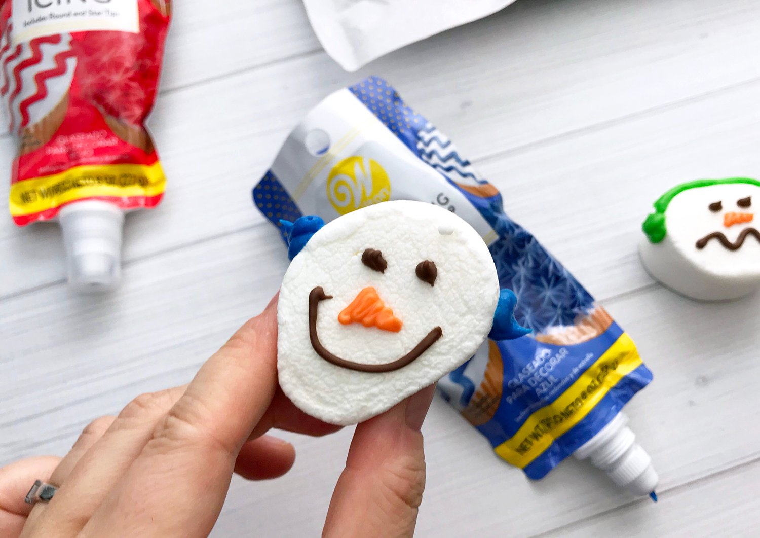 holding up smiling face marshmallow snowman