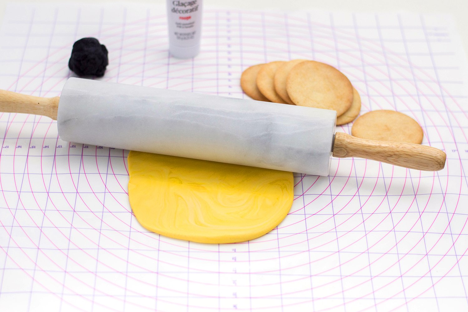 rolling out yellow fondant for heart eye emoji cookies