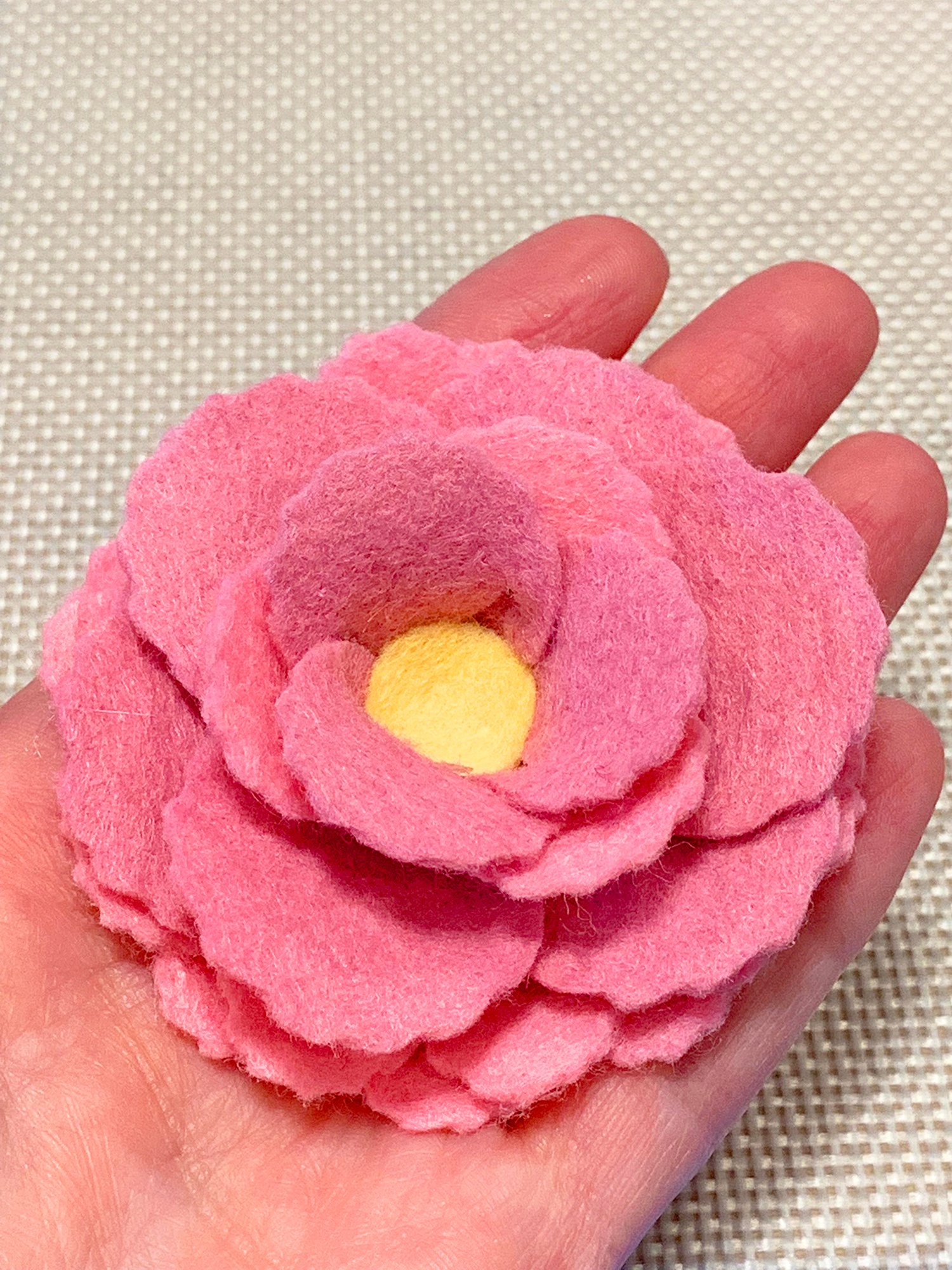 felt flower held in hand