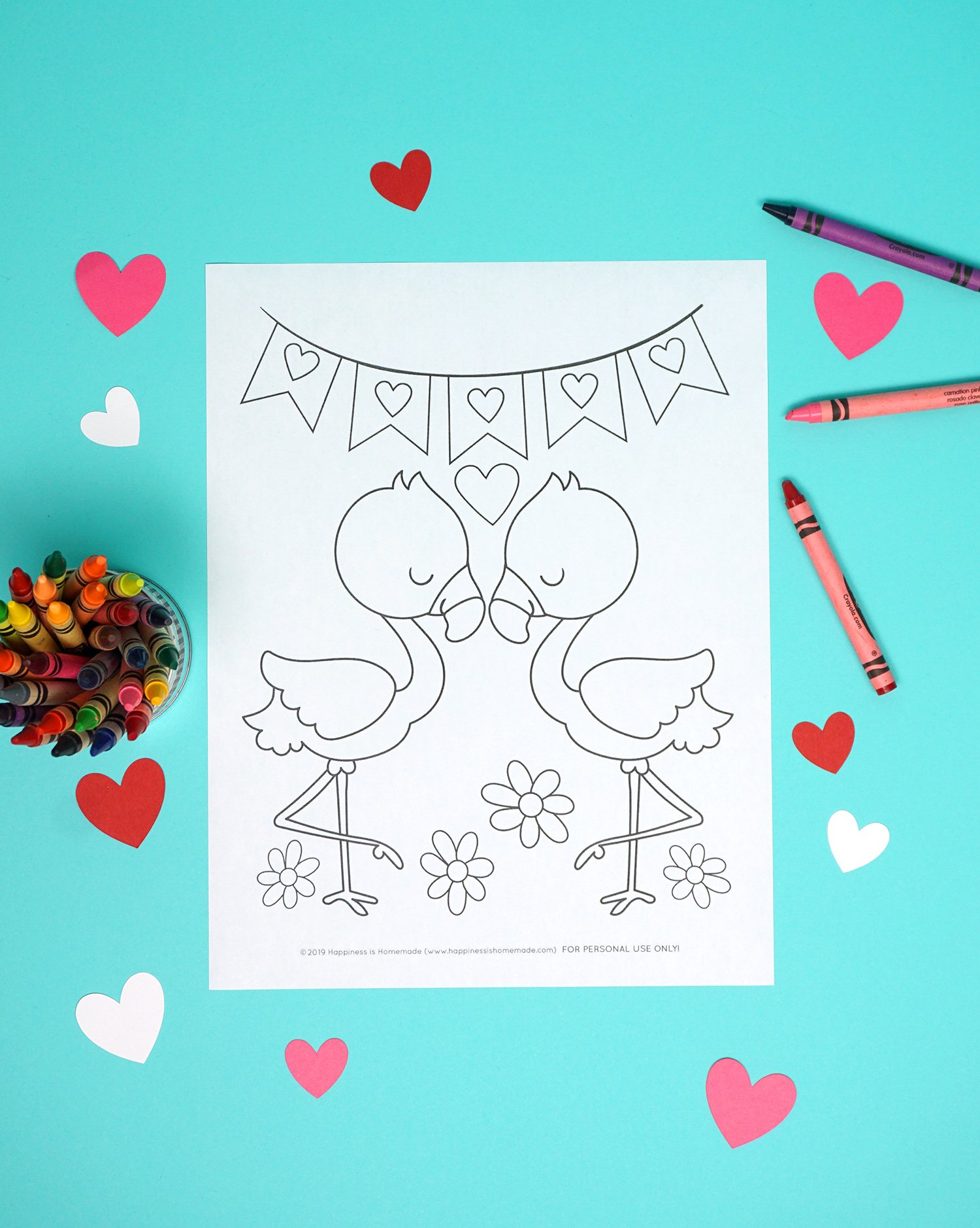 Flamingo coloring page on aqua background with crayons and hearts