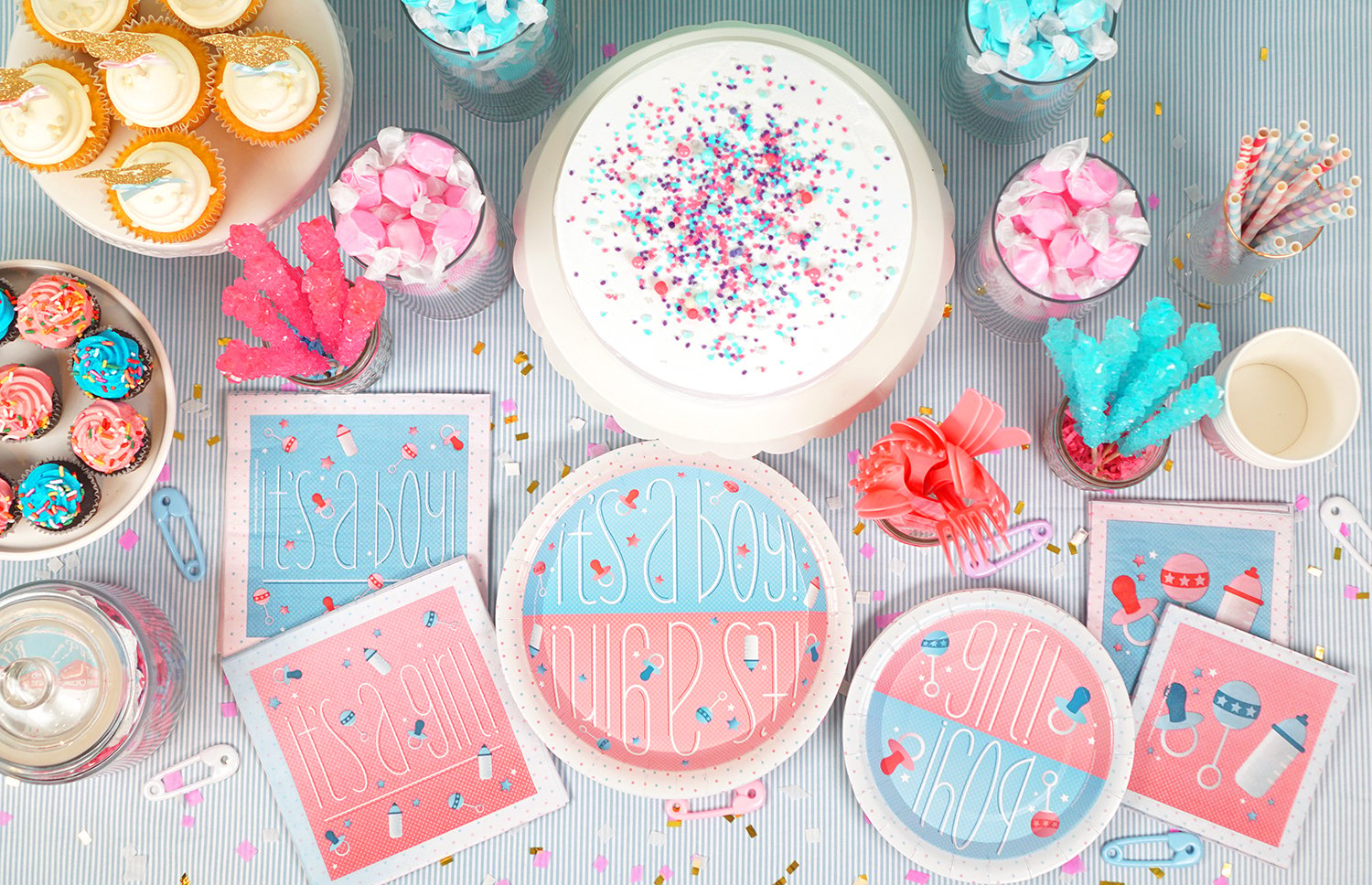 Overhead shot of gender reveal party table and paper goods