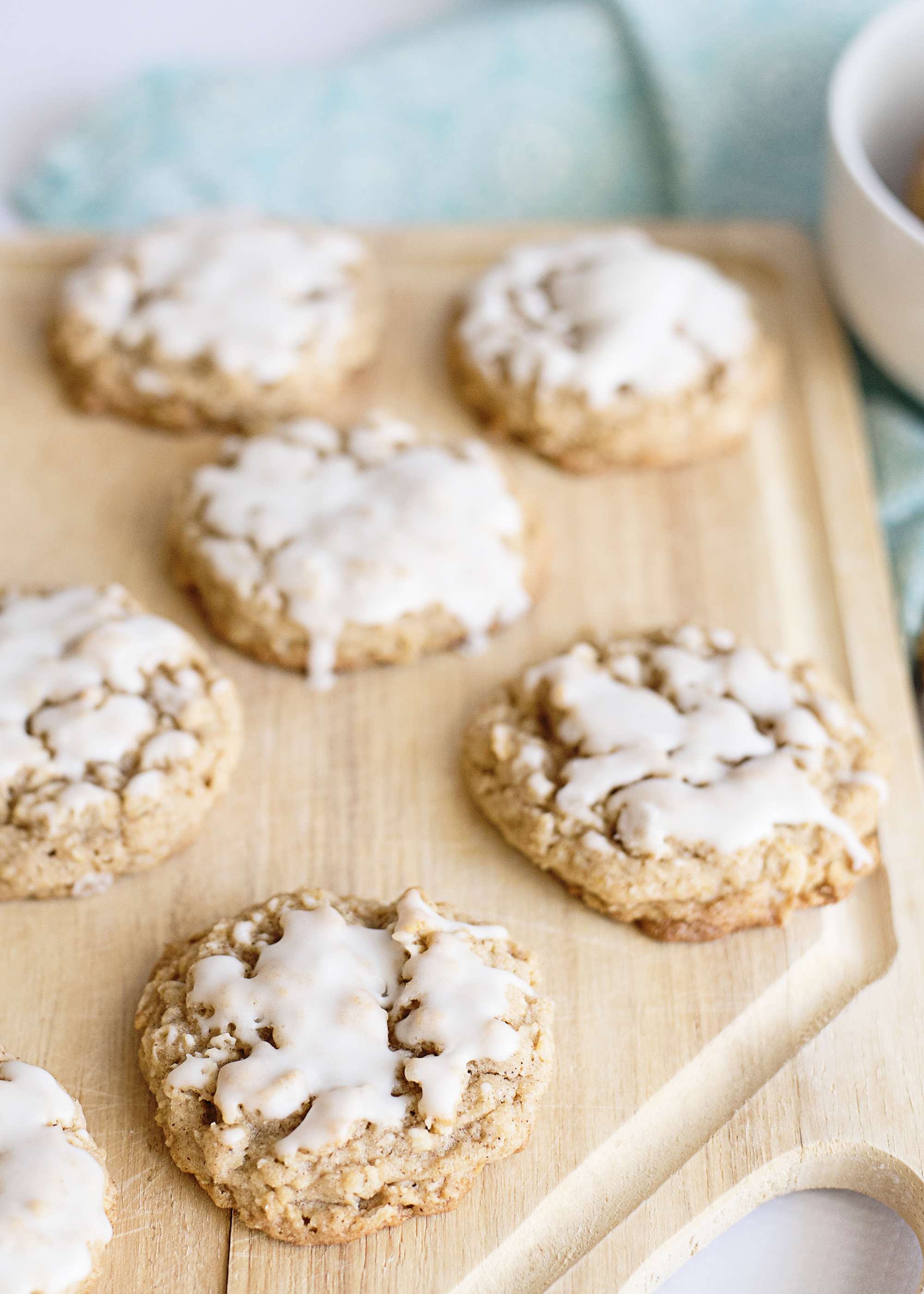 iced oatmeal cookies on cutting board