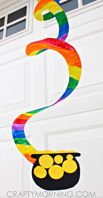 rainbow colored paper twirler hung outside a garage