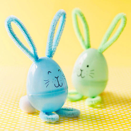 plastic easter eggs with drawn on smiling faces and pipe cleaner ears and feet 