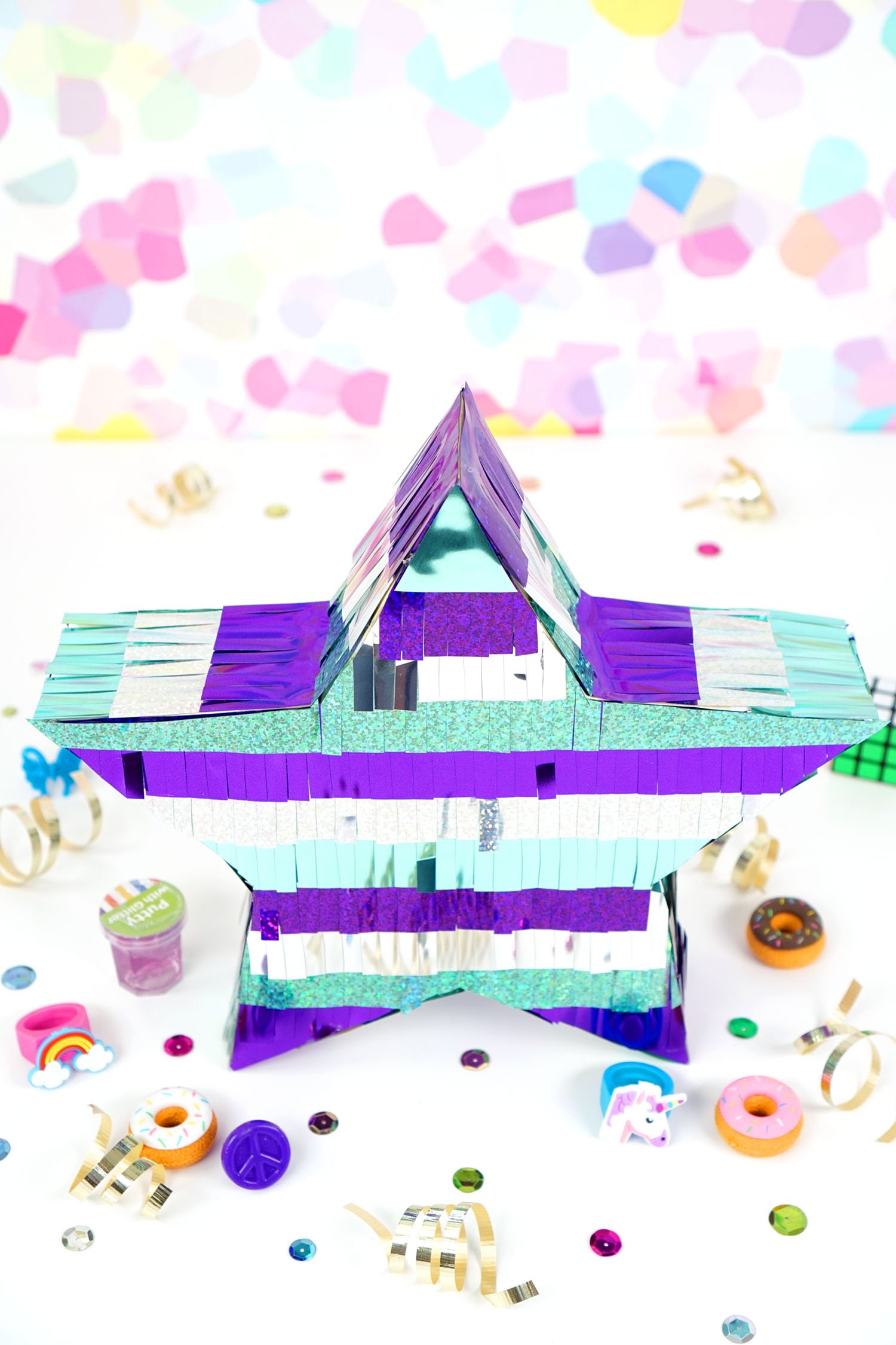 overhead shot of finished star shaped pinata with small toys in background