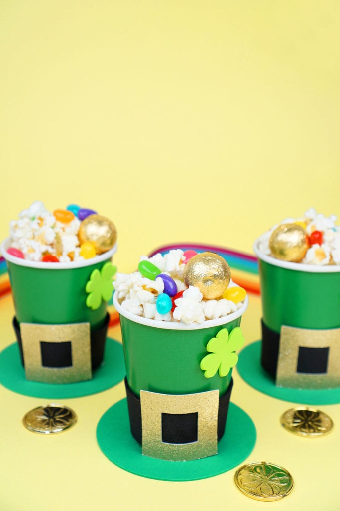 kids treat cups for st patricks day made to look like leprechaun hats filled with popcorn and candies