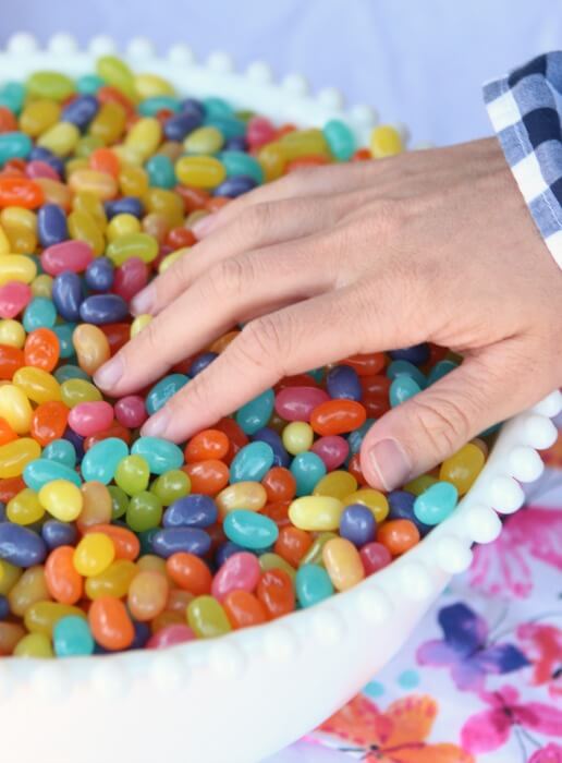 hand reaching into basket of jelly beans