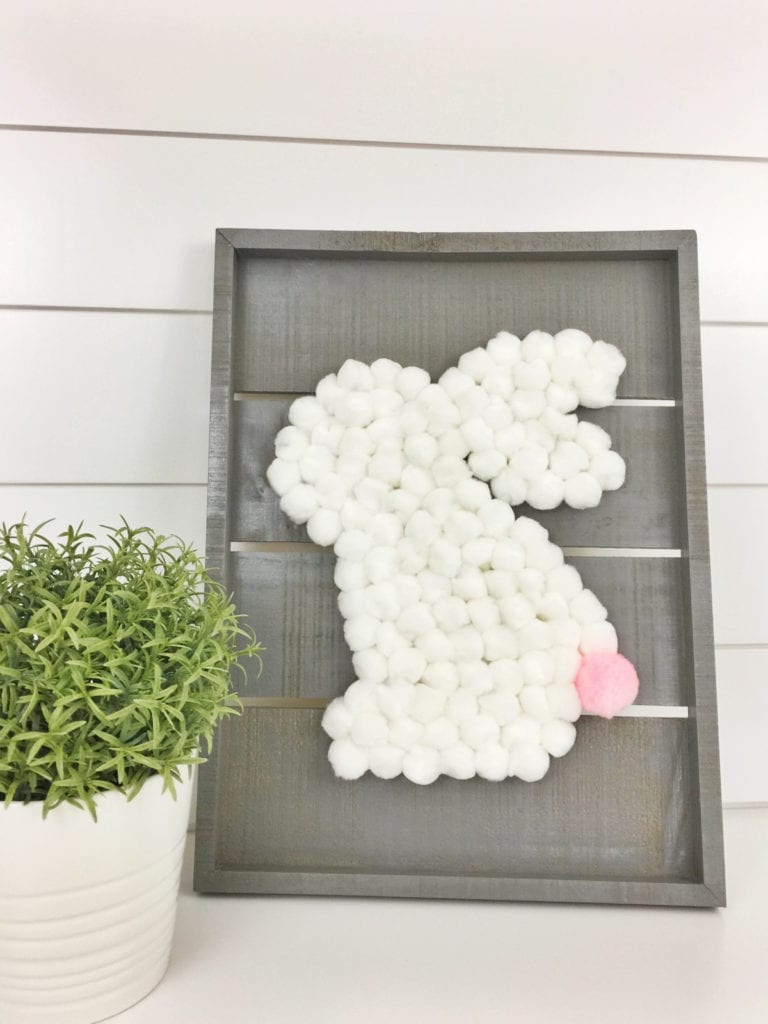 cotton ball easter bunny on wooden sign background