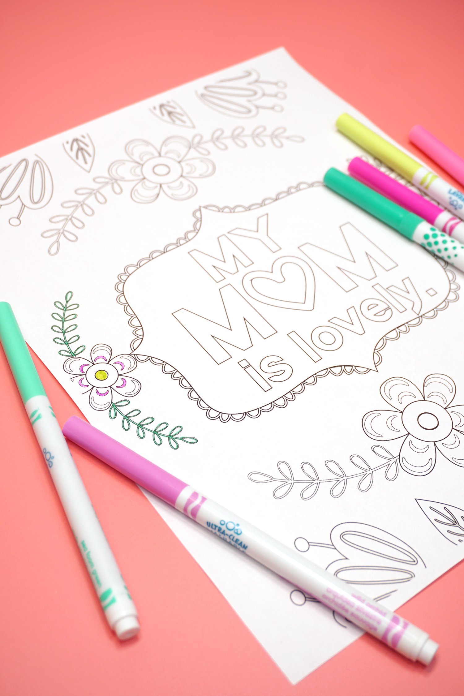 Mother's Day Coloring Page "My Mom is Lovely" with markers on a coral background