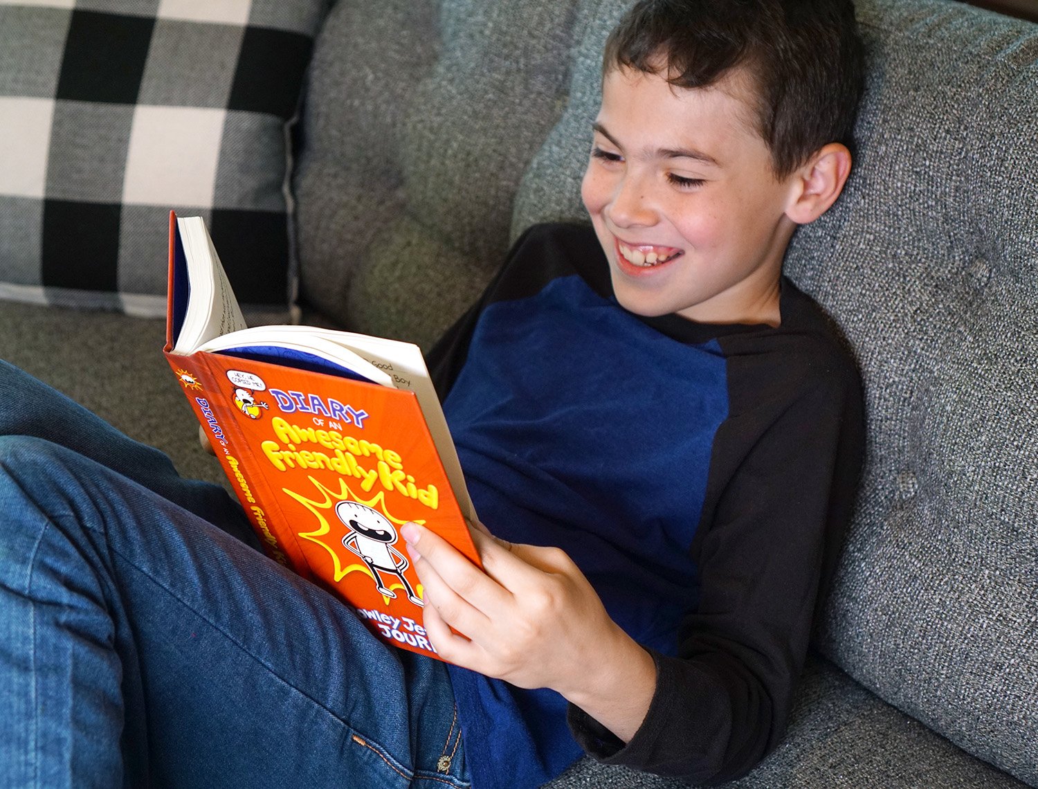 adorable child smiling reading book