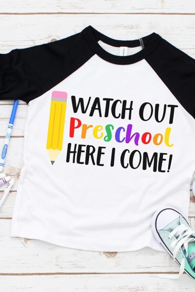 "Watch Out Preschool Here I Come" SVG on black raglan shirt surrounded by colorful markers and kids shoes