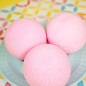 pink bath bombs on blue platter