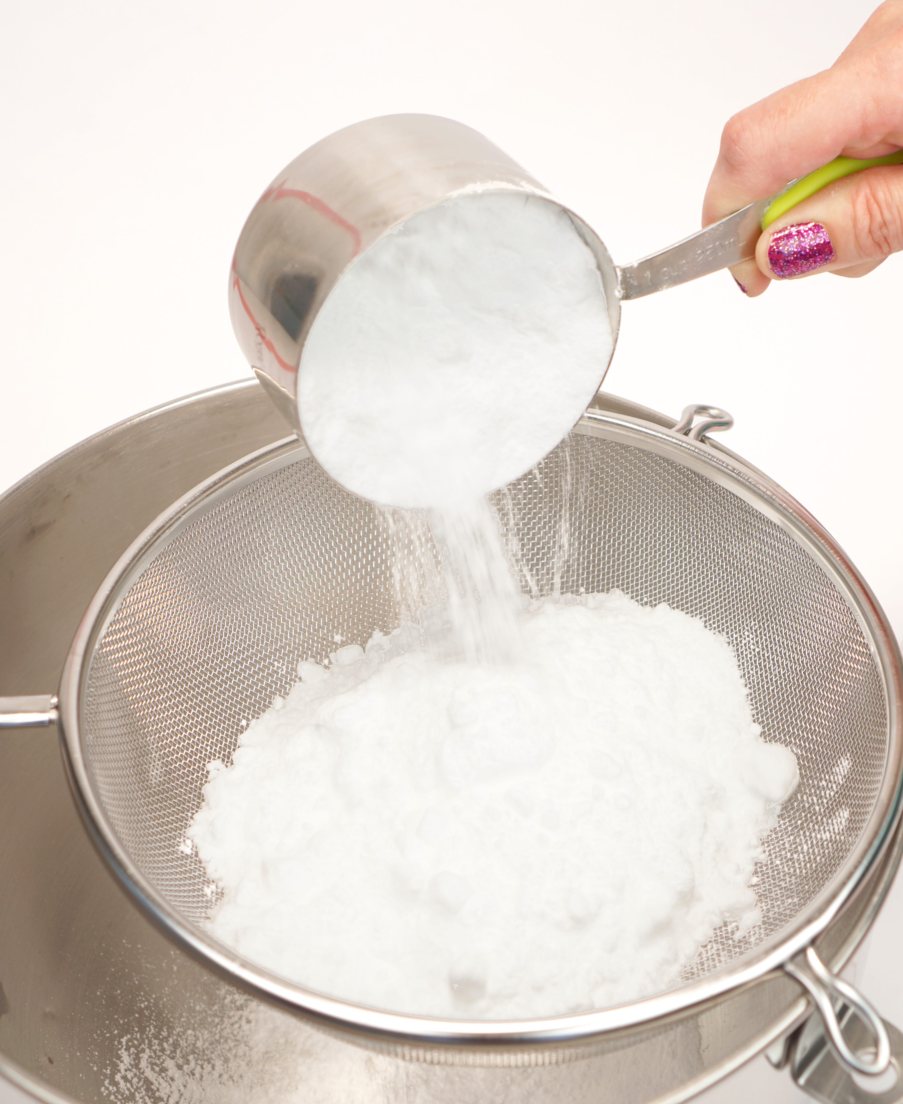 Sifting baking soda for bath bombs