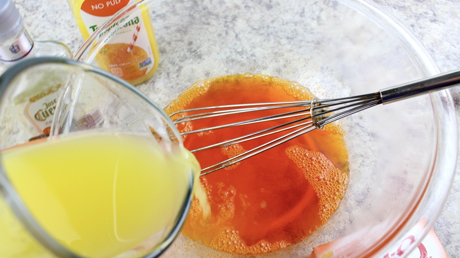 whisking orange juice into mixture