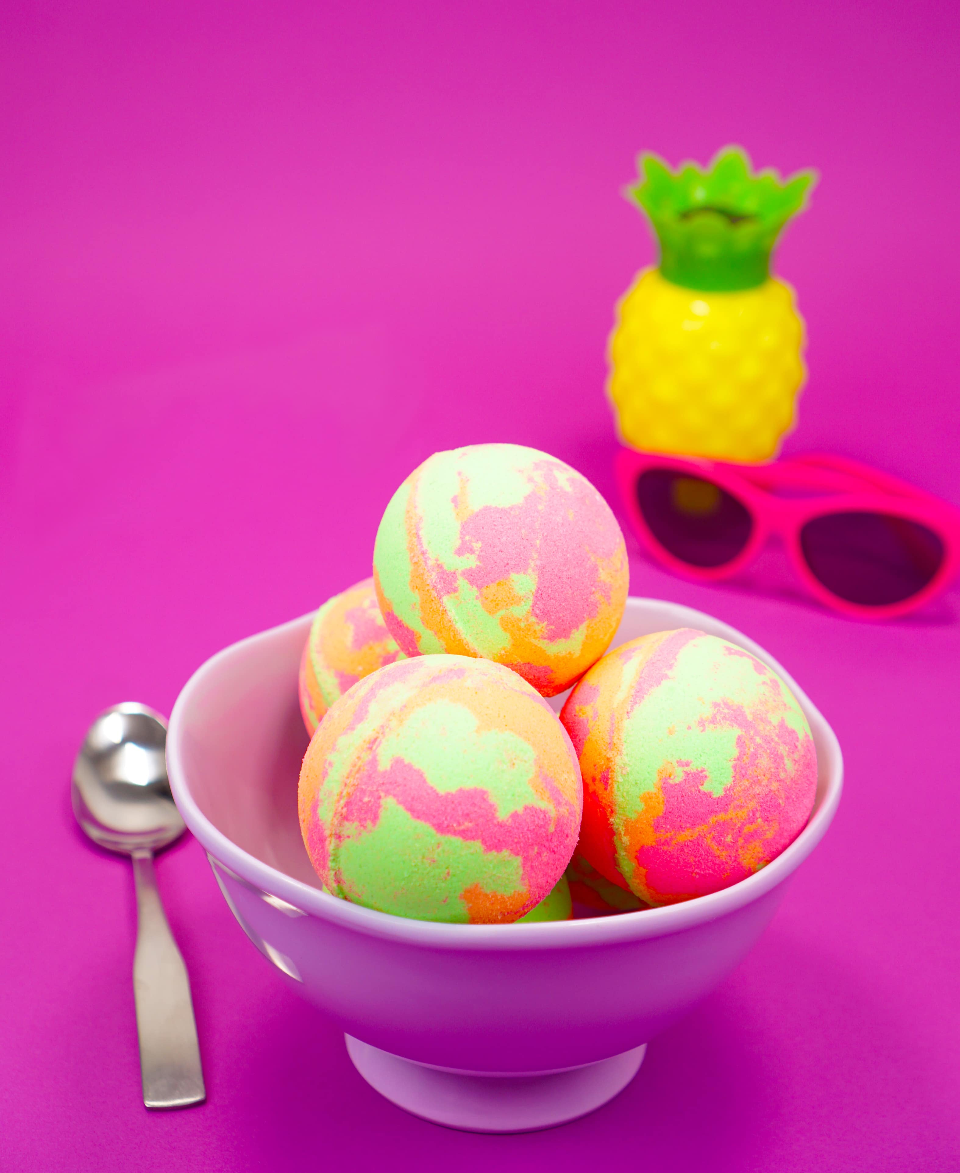 Rainbow sherbet bath bombs in a bowl