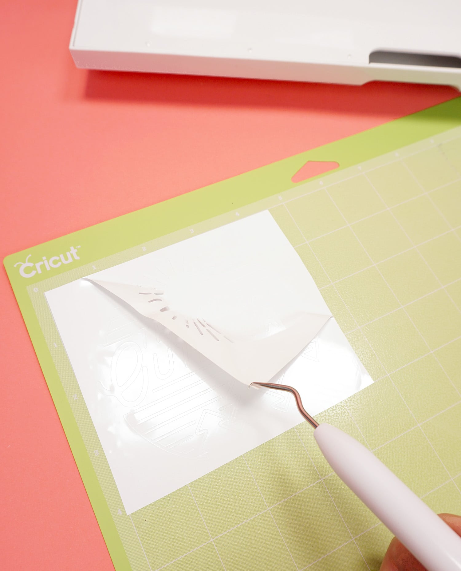 weeding materials from vinyl on the cricut cutting mat