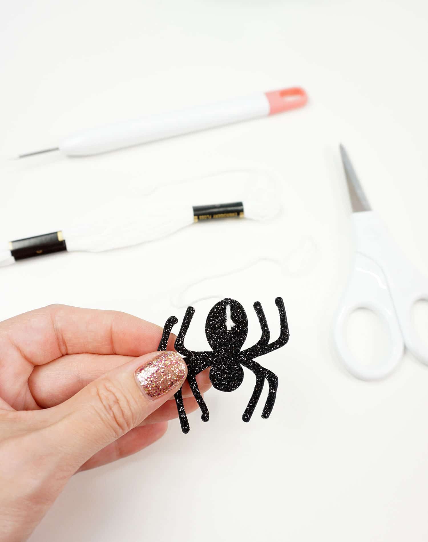 holding glitter spider cut with cricut 
