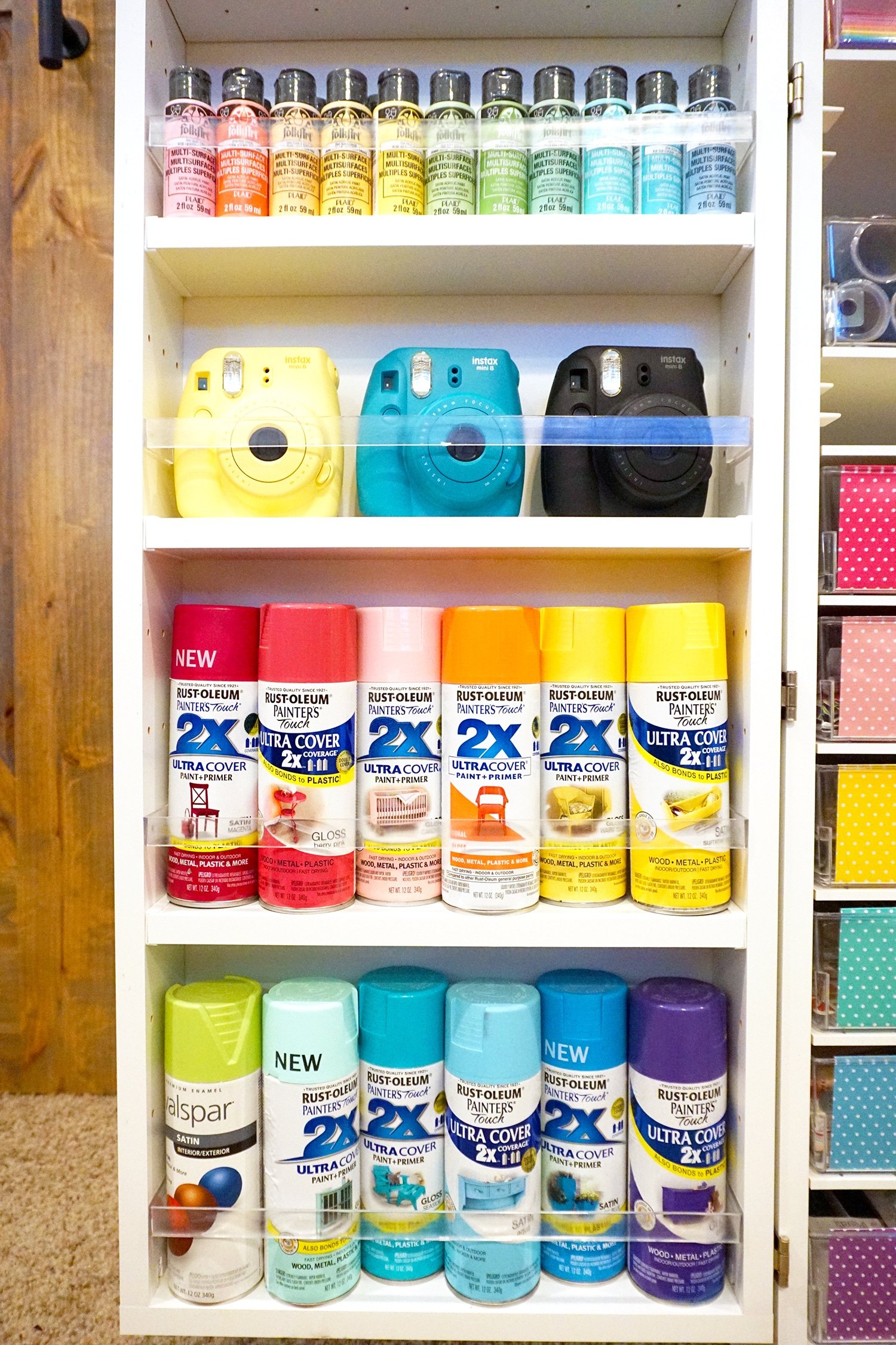 rainbow arrangement of spray paints and cameras
