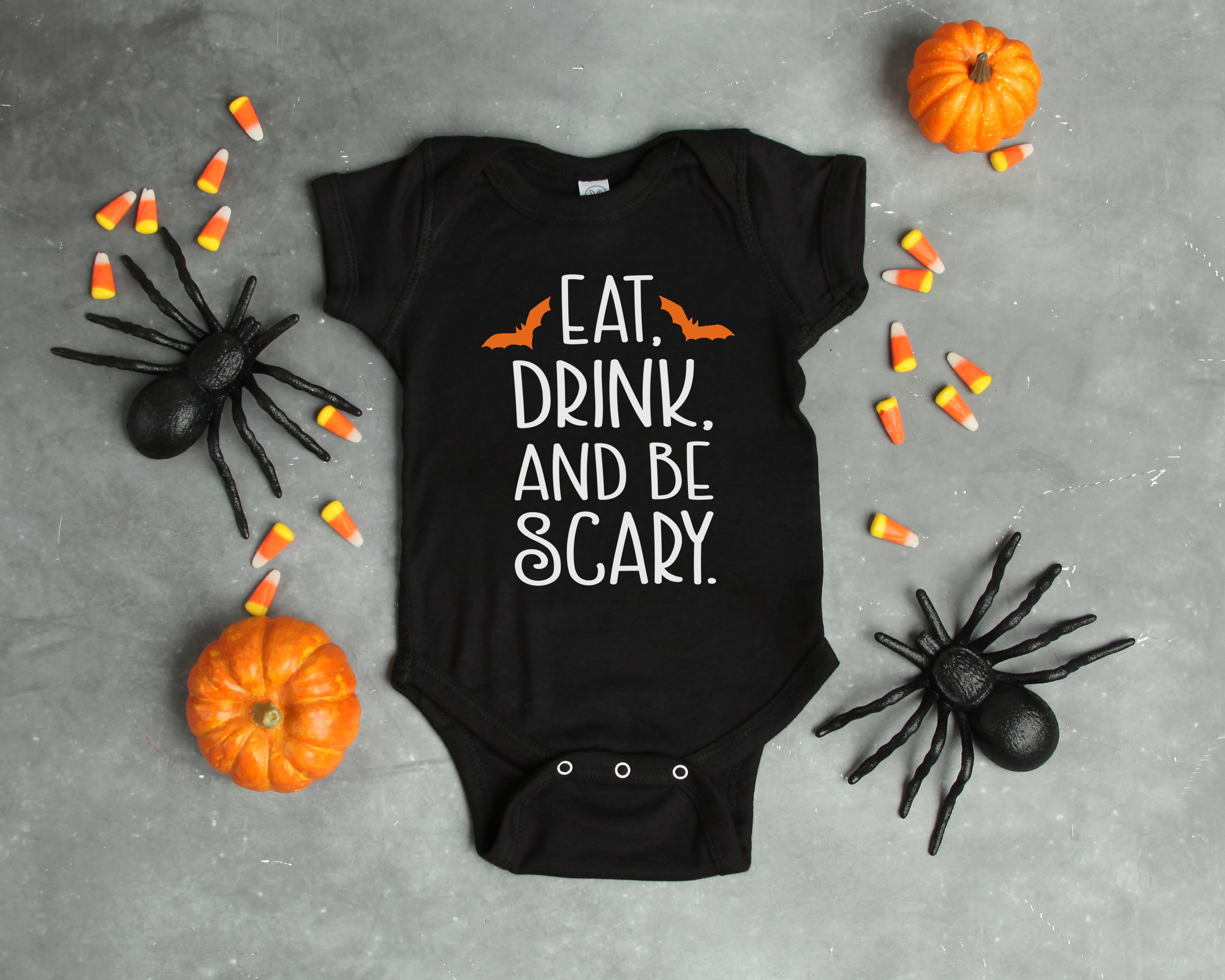 halloween svg file on black onesie with halloween decorations