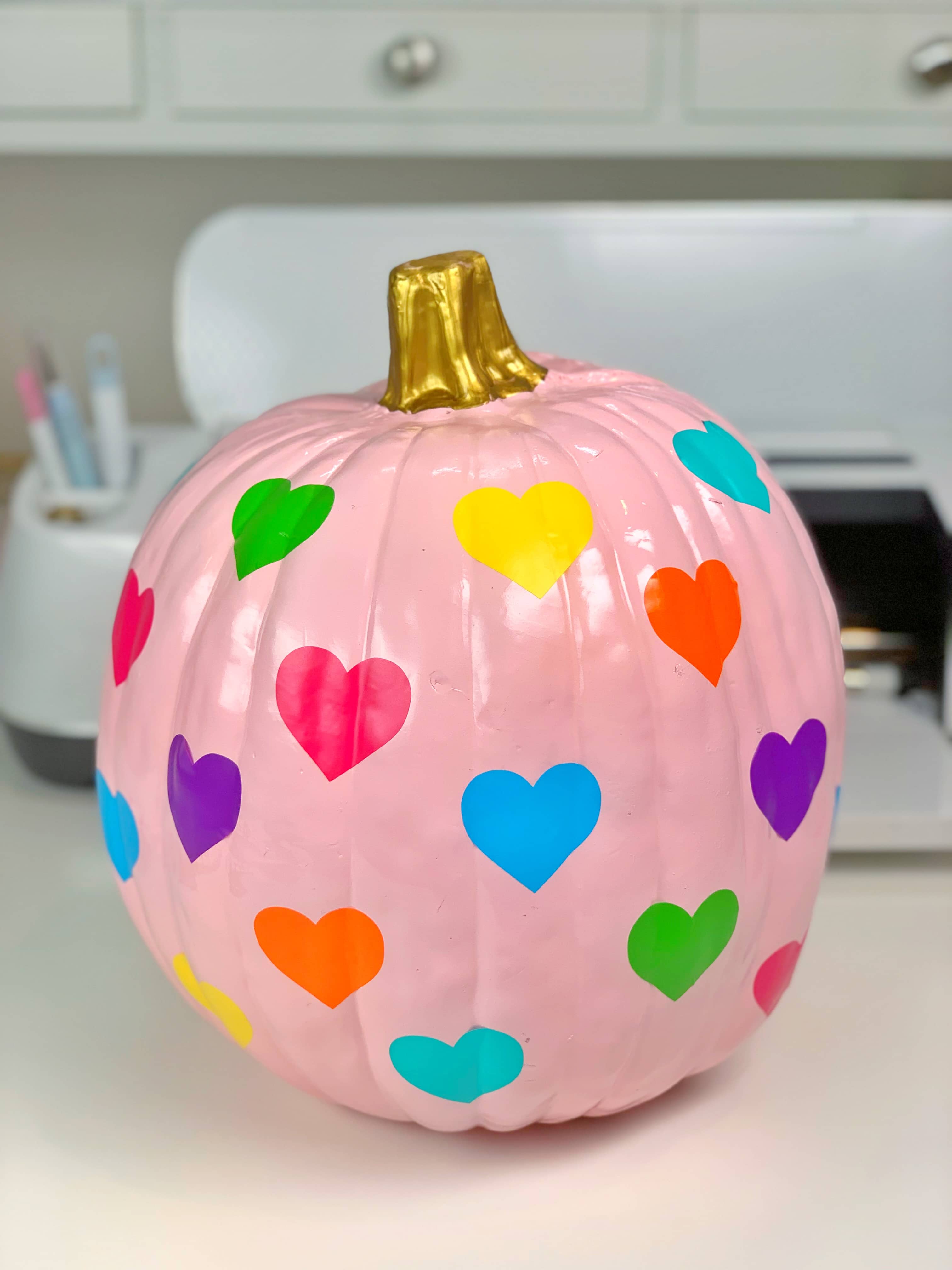 cricut rainbow hearts adhered to pink pastel pumpkin