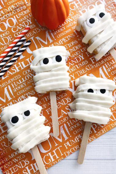 Mummy Rice Krispies Treats on an orange Halloween background