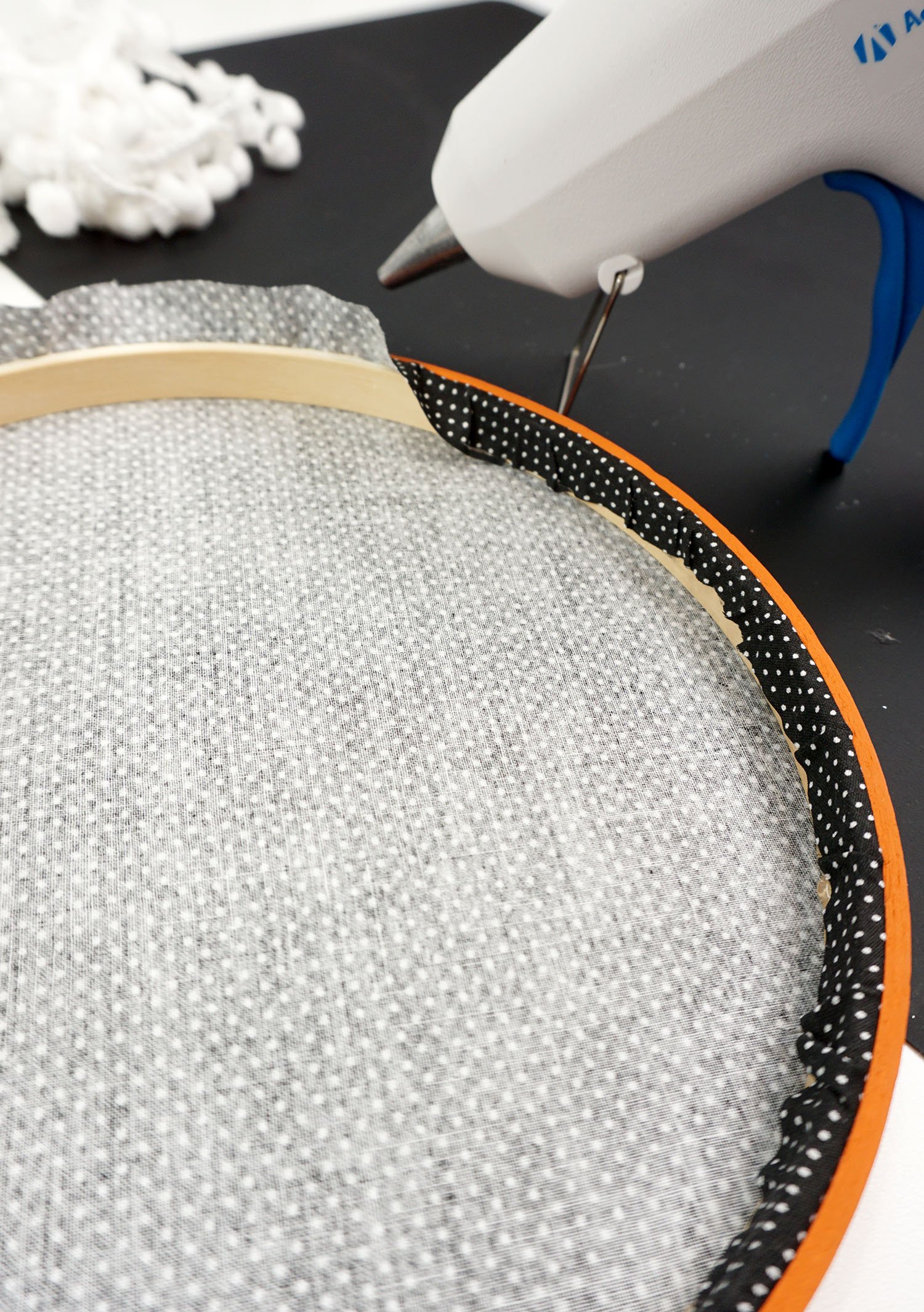finish glueing the excess onto the embroidery hoop