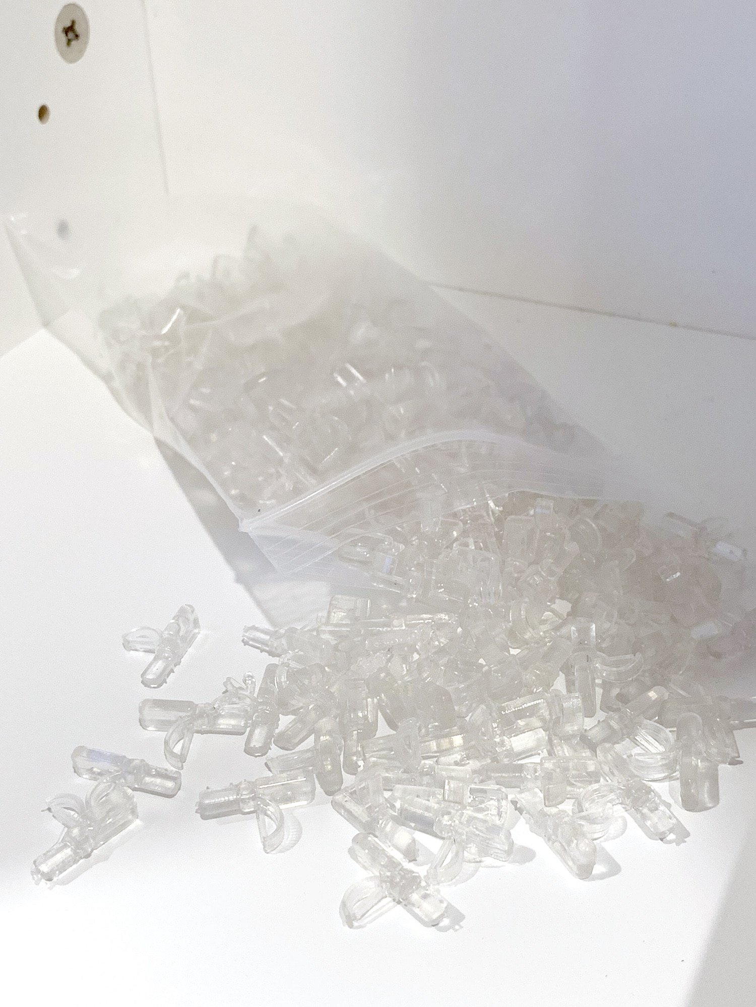 clear plastic bag of shelf pegs