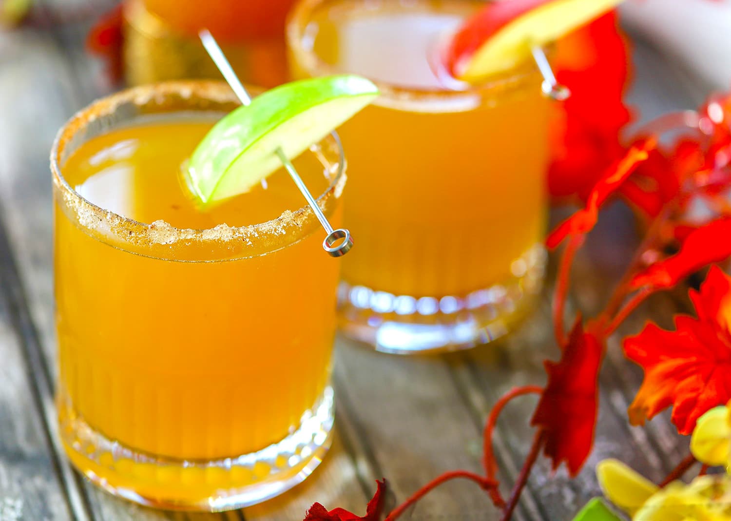 spiced apple cider mimosas garnished with apples