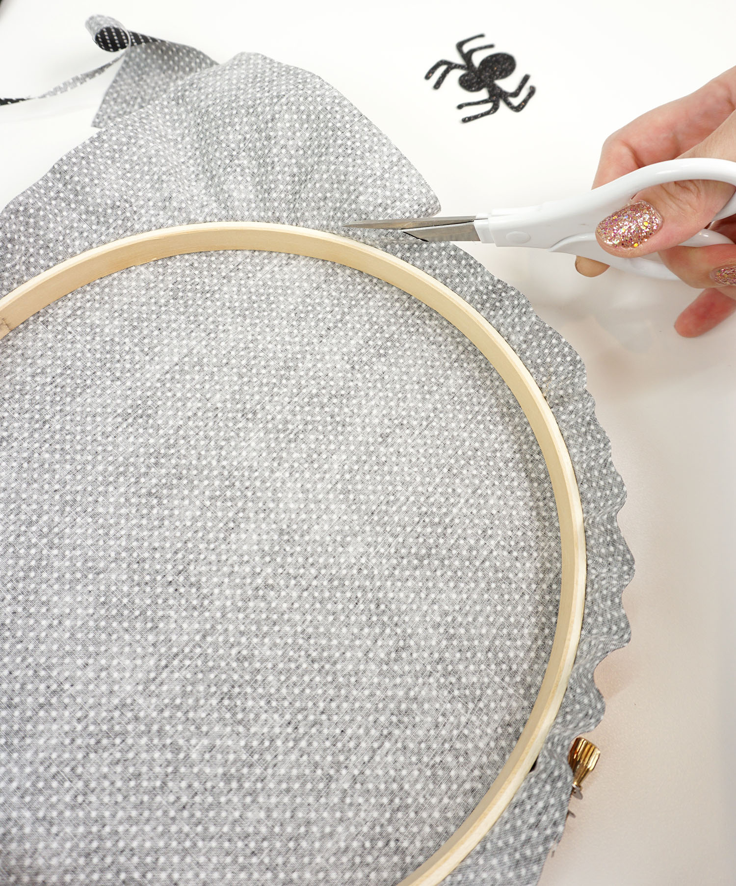 cutting excess material from embroidery hoop