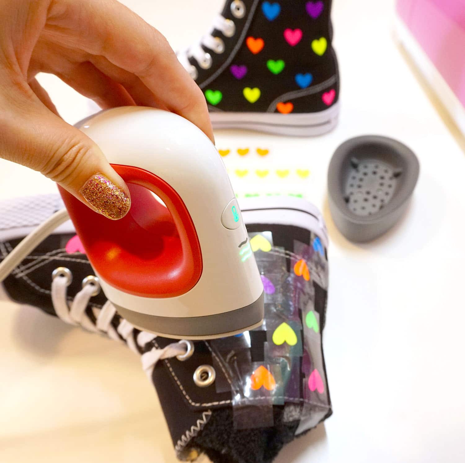 using cricut mini press to iron on hearts to shoes