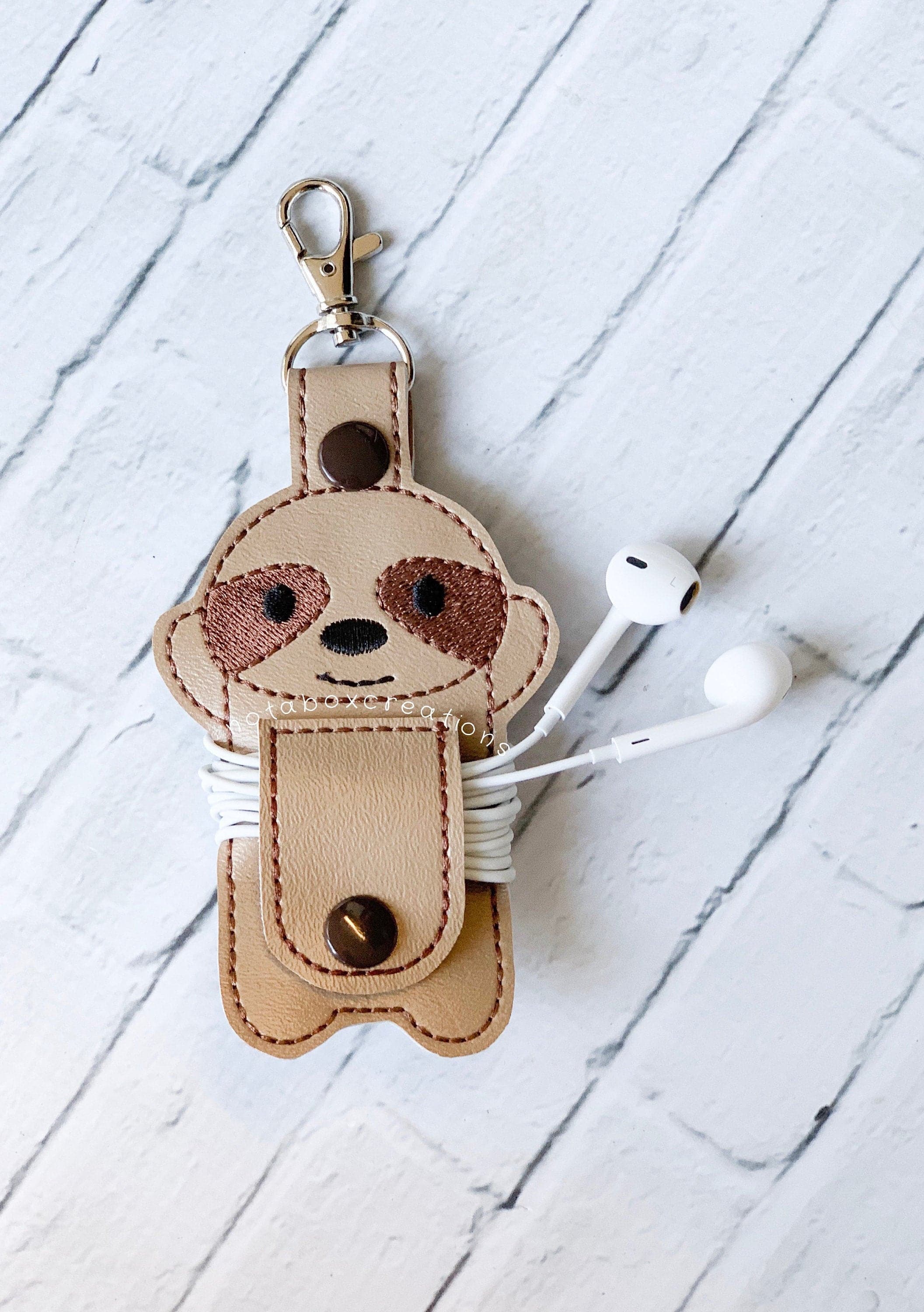 sloth ear bud case and cord wrap